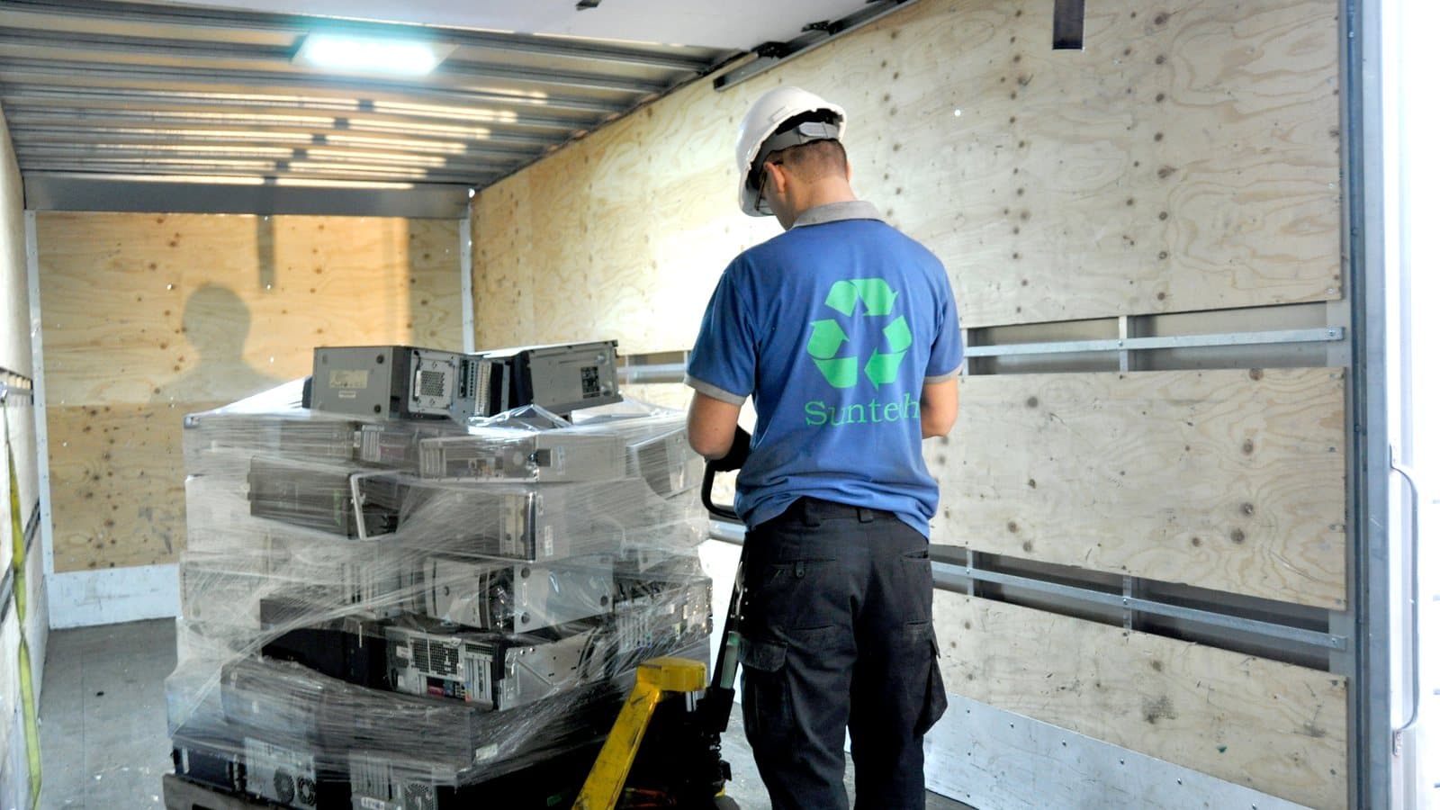 SunTech Recycle staff loading a pallet of retired computers for collection in Greater Montréal